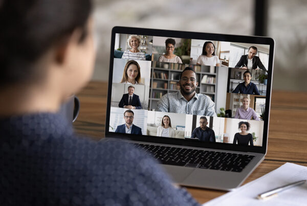Labor Laws for Remote Employees - Close-up of a Person Using a Laptop to Have an Online Meeting