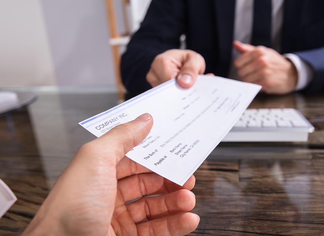 Payroll - Close-up of a Man Giving a Pay Check