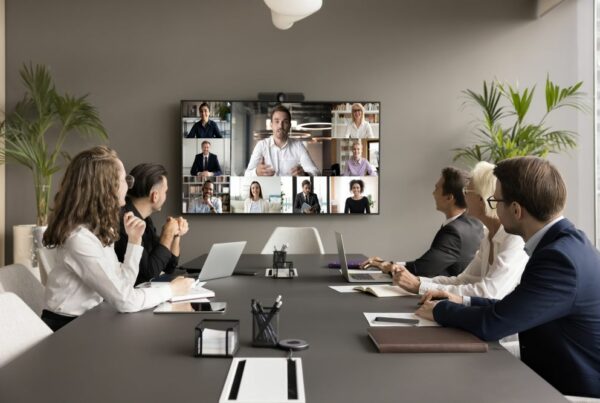 Remote workers in a video conference with employees in the office